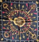 A Hermes Paris "Les Cles" silk scarf in black, red, and gold, hand rolled edges