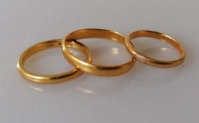 A 22ct yellow gold wedding band, size O, hallmarked and two others, unmarked, but testing for 22ct