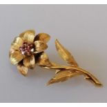 A ruby-set flower brooch in 18ct yellow gold, with six round-cut rubies to the centre