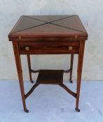 An Edwardian rosewood envelope card table with string inlay, frieze drawer with turned brass handles