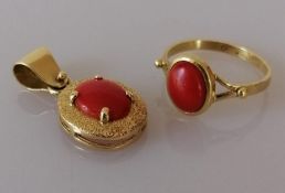 An Italian oval coral pendant on a textured gold mount