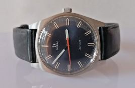 A men's 1960s Omega Geneve wristwatch with black dial, orange seconds hand