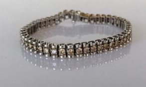 A white gold tennis or line bracelet with fancy round-cut diamonds