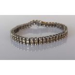 A white gold tennis or line bracelet with fancy round-cut diamonds