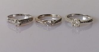 Three 18ct gold diamond rings: a cluster ring centering on a princess-cut diamond, 2.2 x 2.2mm