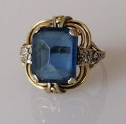 A gem-set dress ring on a yellow gold setting with diamond decoration to shoulders, size Q 1/2, stam