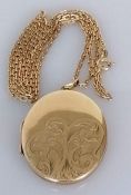 An oval gold locket, 40mm x 32mm, with etched decoration on a gold neck chain, 58 cm, both hallmarke