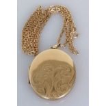 An oval gold locket, 40mm x 32mm, with etched decoration on a gold neck chain, 58 cm, both hallmarke