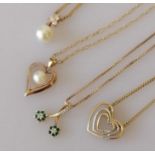 Four pendant necklaces in yellow and white gold