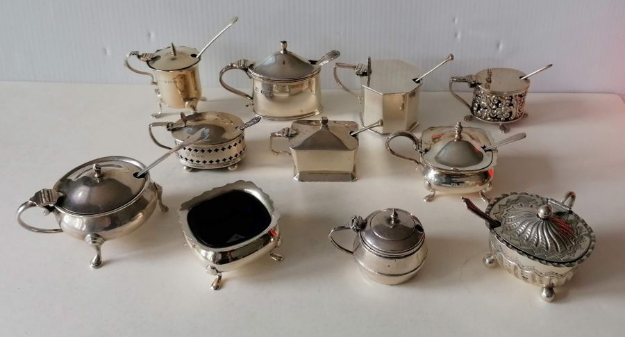 An assortment of eleven Victorian, Edwardian and later silver mustard pots, all with glass liners in