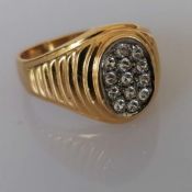 A gold signet ring with an oval cubic zirconia panel, size W, stamped and tests for 18ct, 8.7g