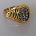 A gold signet ring with an oval cubic zirconia panel, size W, stamped and tests for 18ct, 8.7g