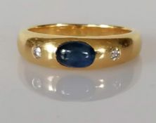 A synthetic sapphire and diamond-set three stone ring, the cabochon-cut medium blue synthetic sapphi