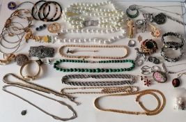 A selection of mixed costume jewellery to include bead necklaces, brooches, bangles, rings, etc