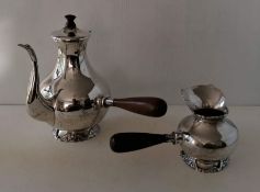 A Colombian silver hot chocolate pot and brandy warmer, both of baluster form