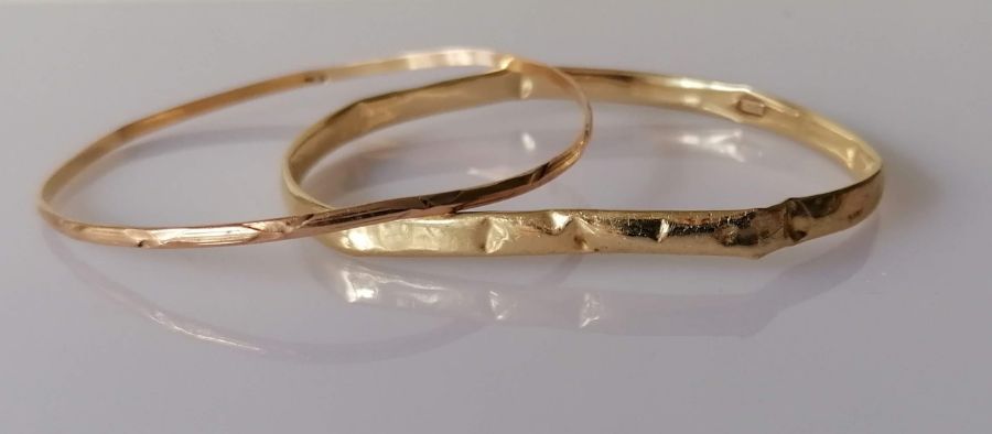 A yellow gold bangle, stamped 14K for Michael Anthony, New York, 6.1g and another