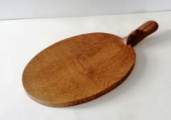 A Robert Thompson of Kilburn 'Mouseman' oak cheeseboard, 39cm W, including handle, in good condition