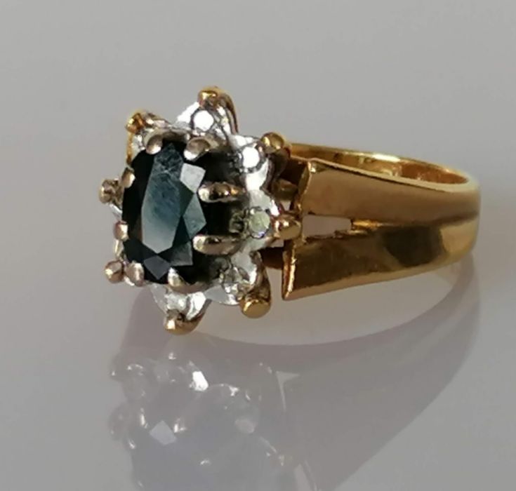 A vintage sapphire and diamond cluster ring, the claw-set central oval-cut sapphire - Image 2 of 3