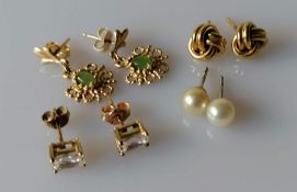 Two pairs of Tiffany & Co. stud earrings: one yellow gold love knot, the other pearl, both signed an