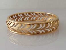 A yellow gold pierced bangle, unmarked, tests for 18ct, 44.6g