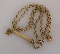 A 9ct yellow gold rolo neck chain, 58 cm, hallmarked, 10.4g with a gold plated key pendant