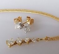 A graduated four-stone diamond pendant on chain, 43 cm, on an 18ct yellow gold claw setting