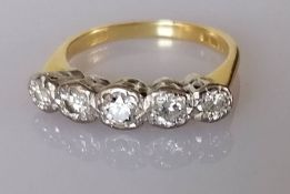 An 18ct gold graduated five-stone diamond half hoop ring, illusion set