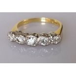 An 18ct gold graduated five-stone diamond half hoop ring, illusion set