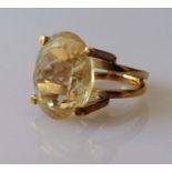 An oval citrine dress ring in a yellow gold setting, the faceted citrine 20 x 16mm, size, M, stamped