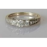 A 14ct white gold ring channel-set with eleven graduated round-cut diamonds,