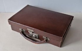 A British-made vintage tan leather lockable travel case with fitted interior for stationery