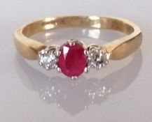 A 9ct yellow gold three-stone diamond and ruby ring, size M1/2, 2g, with box