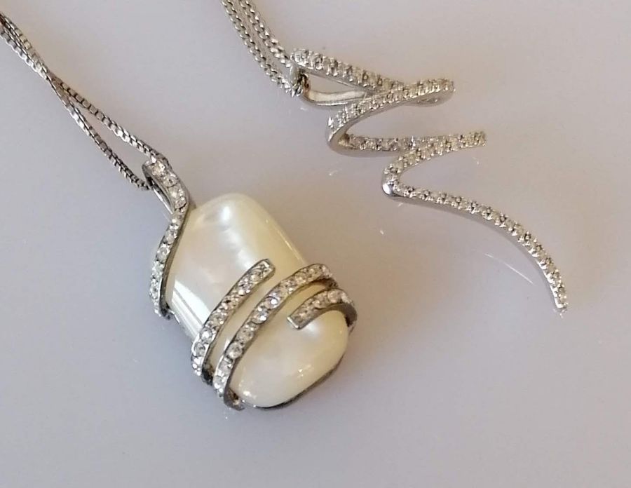 Two silver chain necklaces, one with a mother-of-pearl pendant surmounted with tiny diamonds