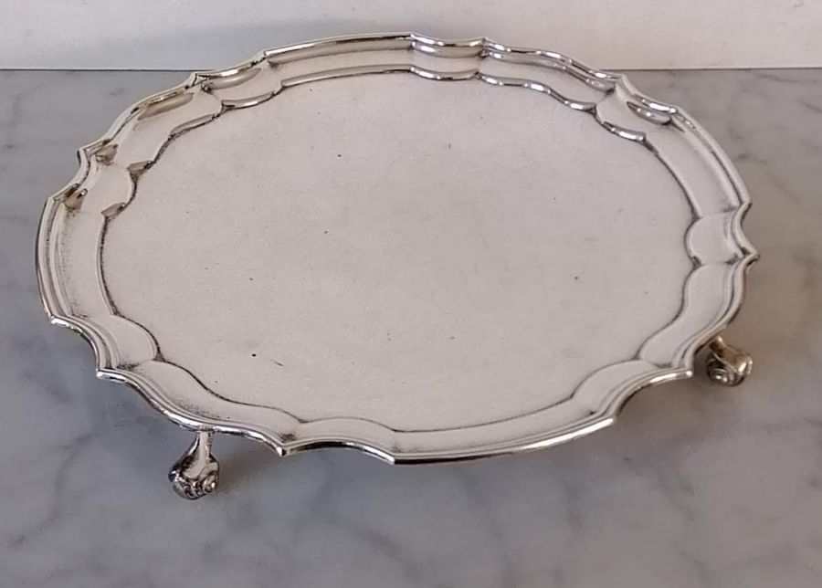 A QEII silver salver with pie crust border on four scrolled feet by Roberts & Dore Ltd., Birmingham,