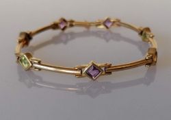 A 9ct yellow gold and multi-gem bracelet set with seven mixed-cut amethysts, peridot and citrine