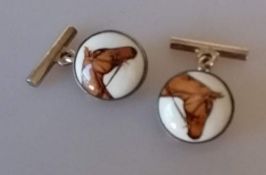 A boxed pair of .925 silver cufflinks with enamel horse head decoration