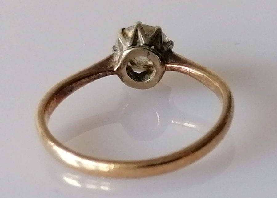 A solitaire diamond ring in a claw-set gold setting, the round-cut diamond approximately 0.75 carats - Image 4 of 4