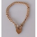 A rose gold curb-link chain bracelet with heart locket, 18 cm, unmarked, tests for 9ct, 9.45g