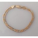 An Italian tri-gold herringbone bracelet, stamped 750, 17 cm, 8.4g