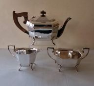 An Art Deco silver tea service with faceted design, each piece raised on four feet, hallmarked