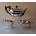 An Art Deco silver tea service with faceted design, each piece raised on four feet, hallmarked