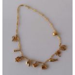 A 9ct yellow gold charm necklace to include a cuckoo clock, Punch and Judy and Old Woman