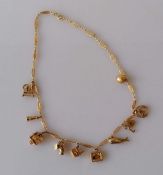 A 9ct yellow gold charm necklace to include a cuckoo clock, Punch and Judy and Old Woman