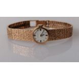 A ladies Jean Renet dress watch in a 9ct gold textured strap, hallmarked, 22.7g (without mechanism)