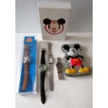 A vintage manual wind Mickey Mouse watch, Poo Bear, a cased Looney Tunes Disney watch and two other