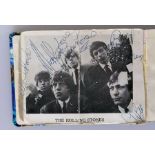 A Rolling Stones signed promo photo, circa. 1963, glued into an autograph book