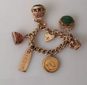 A yellow gold charm bracelet to include a mounted Edwardian gold full sovereign, three gold rings