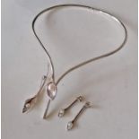 A cased Amanda Cox parure comprising silver lily torque necklace with cultured freshwater pearl