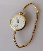 A George V ladies 18ct gold-cased fob watch with Arabic numerals, subsidiary seconds hand, dial 22mm
