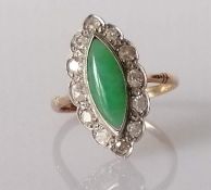 An Art Deco marquise-cut jade cocktail ring surrounded by twelve round-cut diamonds